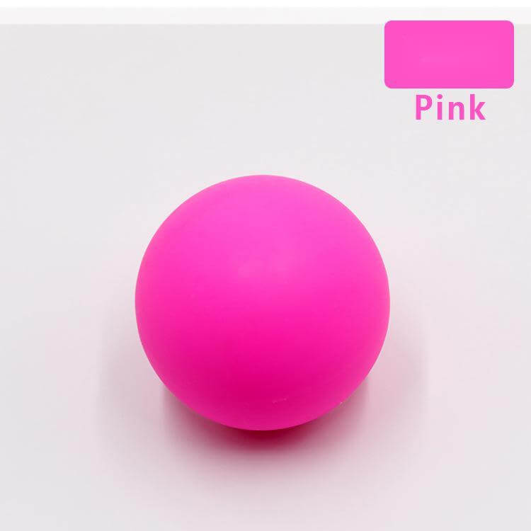 Silicone single ball Fascia ball massage ball in bright pink color on a light background.