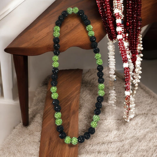 Outfield Green 16" Unisex Baseball Necklace made with rhinestone disco balls on display.