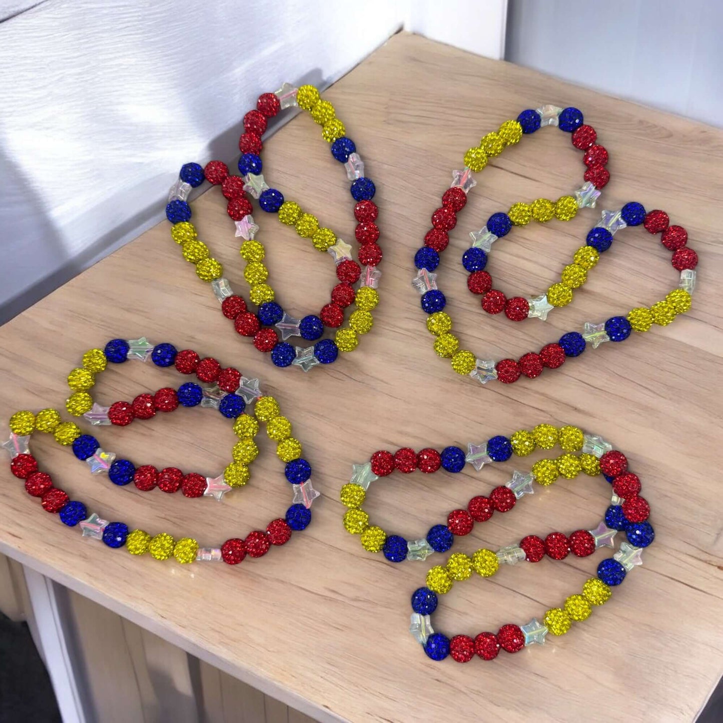 Venezuelan Spirit Necklace - 16" Unisex Baseball in red, yellow, and blue colors on a wooden surface.