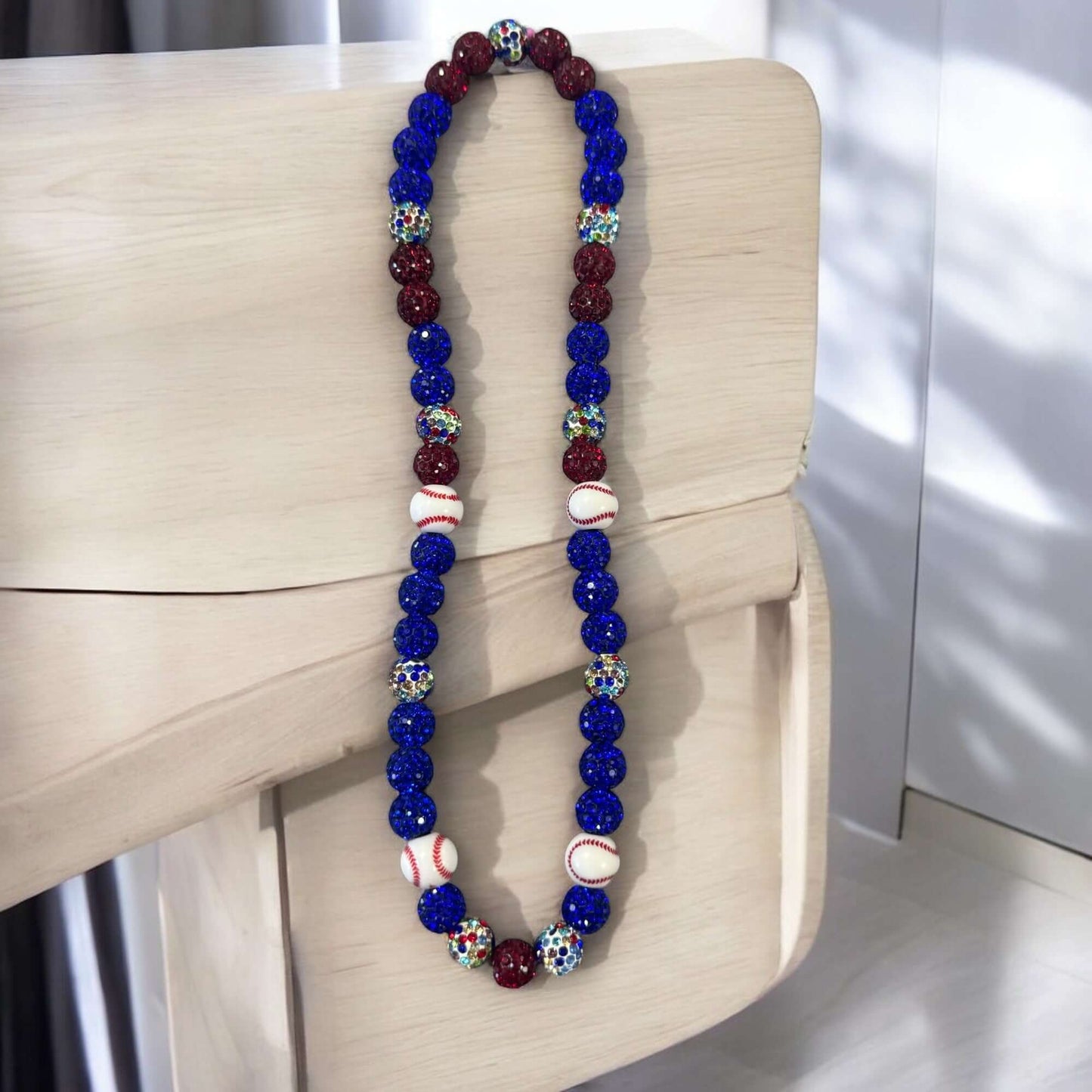 Curveball Blue 16" Unisex Baseball Necklace featuring blue and red rhinestone disco balls with baseball designs