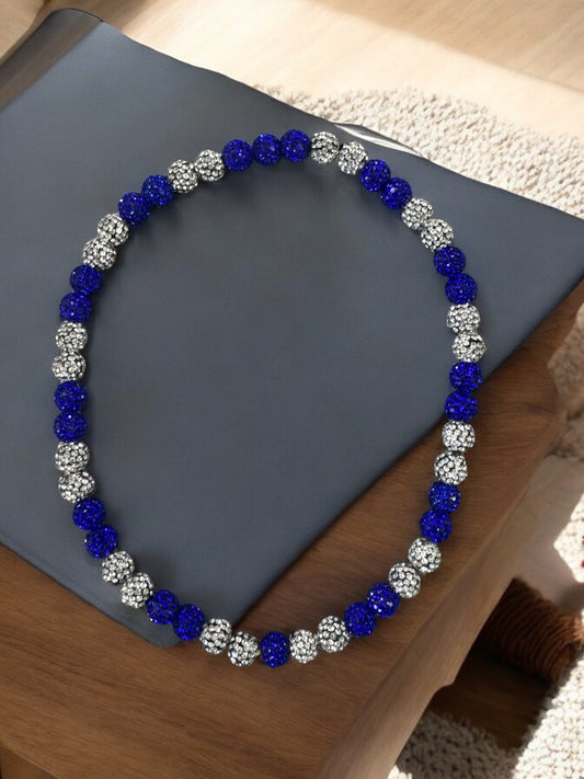 Curveball Blue 16" Unisex Baseball Necklace featuring rhinestone disco balls on a gray surface.