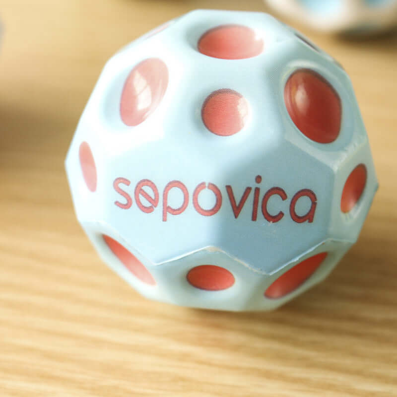 Bouncy Ball Toy Ball featuring a light blue design with red dots and sepovica branding on a wooden surface.
