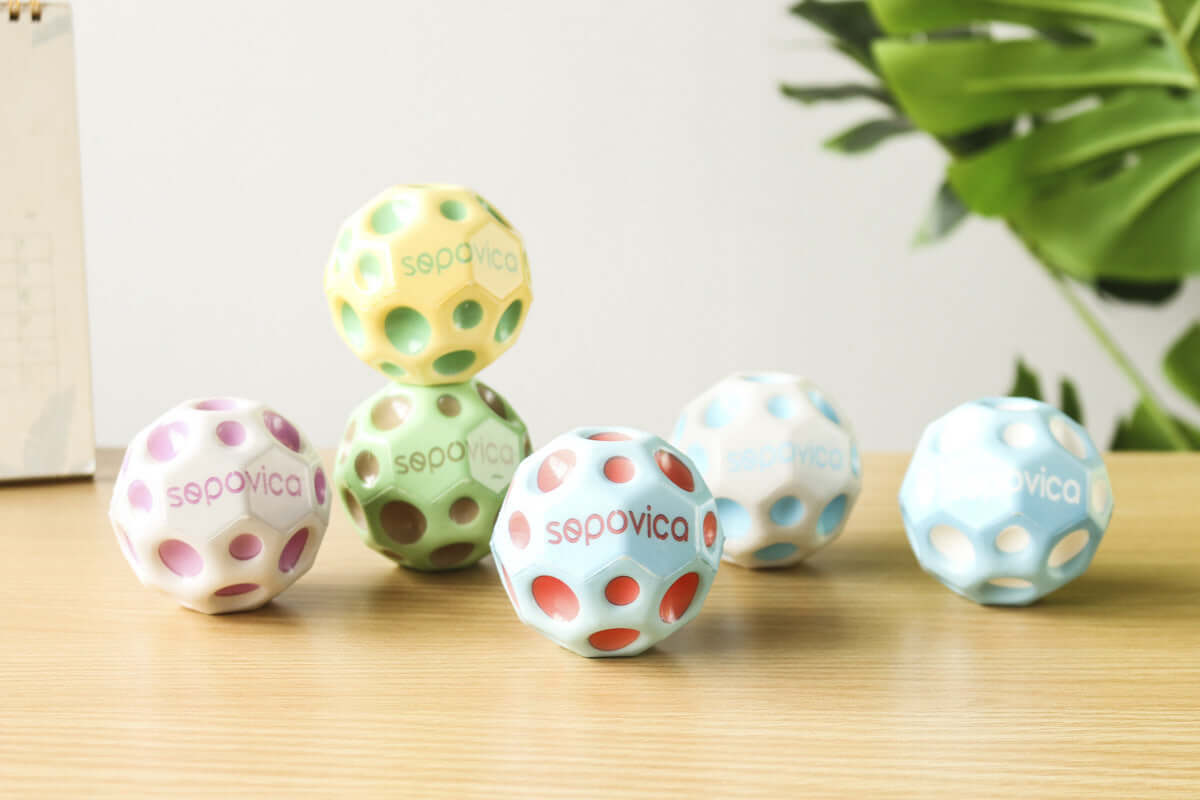 Colorful Bouncy Ball Toy Ball in various colors on a wooden surface, perfect for kids aged 7-14.