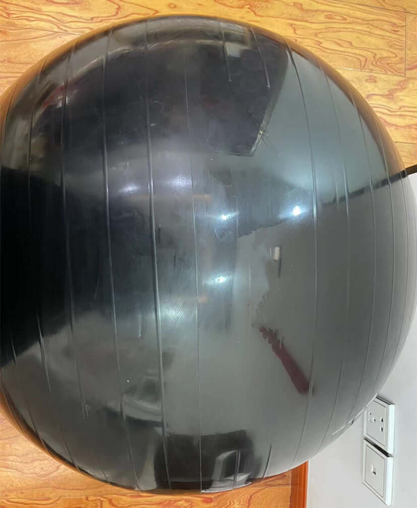 Yoga Hip-thickening Ball thick explosion-proof children's ball pat ball yoga ball Pilates ball on a wooden floor.